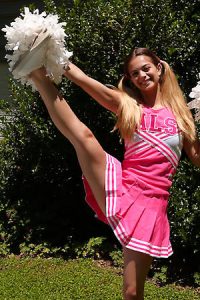 Cute blonde cheerleader spreading